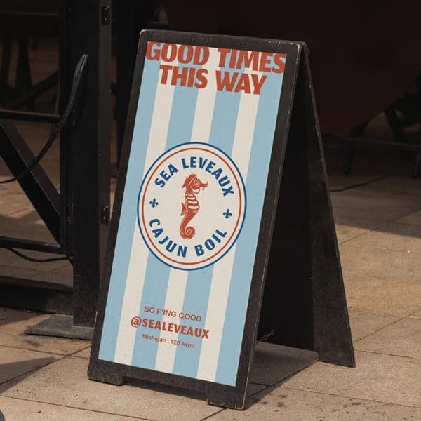 A-frame sign for Sea Leveaux Cajun Boil with a seahorse logo and "Good Times This Way" text.