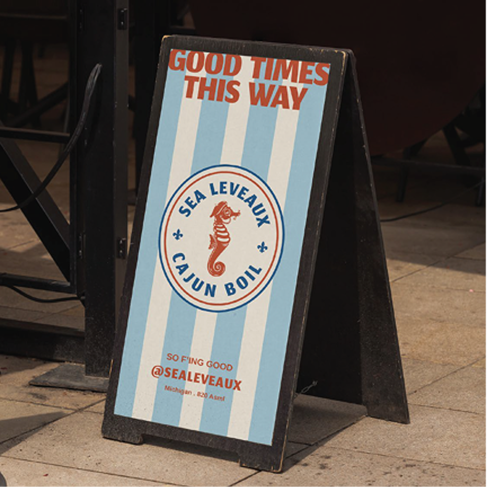 A-frame sign for Sea Leveaux Cajun Boil, with a seahorse logo and "Good Times This Way" text.
